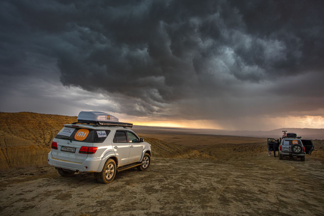 An image of jeeps touring under a stormy sky